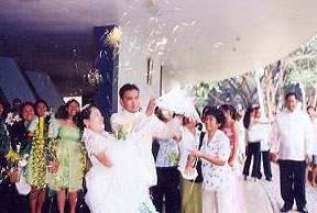 We are showered with confetti while holding the doves